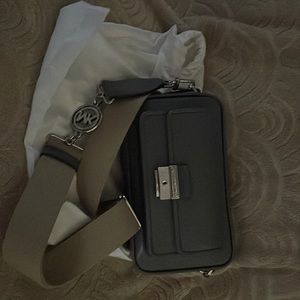 Micheal Kors crossbody camera bag. Brand new. Never used. Color is gray.